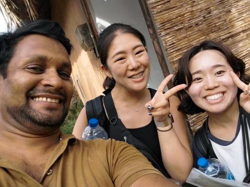 a man and two women making the peace sign with their hands at Lake Cabin in Polonnaruwa