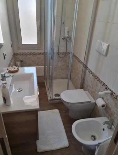 a bathroom with a sink and a toilet and a shower at La dimora di Lorenzo in Giurdignano