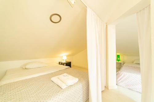 a white bedroom with a bed and a mirror at 4Ever Palace Design&Nature in Alcácer do Sal