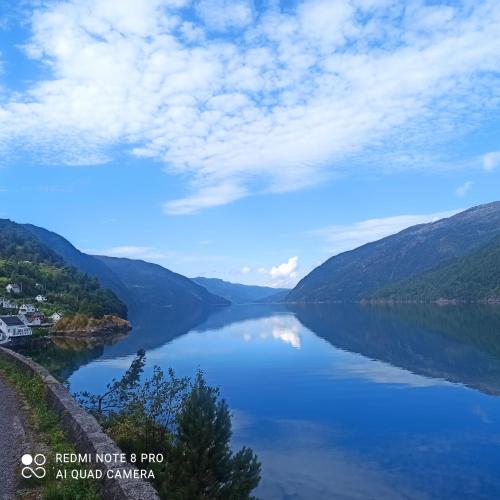 a view of a lake with mountains in the background at Markhus Apartment Near Langfoss in Markhus
