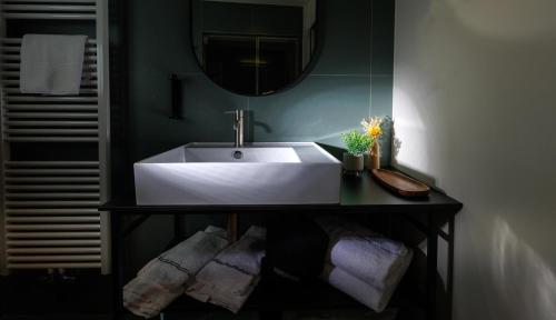a bathroom with a white sink and a mirror at Hotel Stelvio Tirano in Tirano