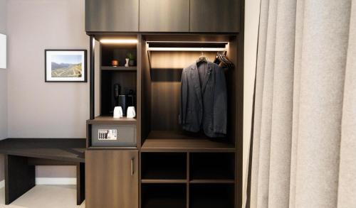 a walk in closet with a suit in it at Hotel Stelvio Tirano in Tirano