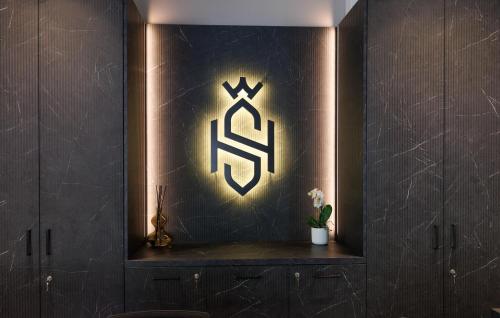 a wall with a illuminated sign on a wall at Hotel Stelvio Tirano in Tirano
