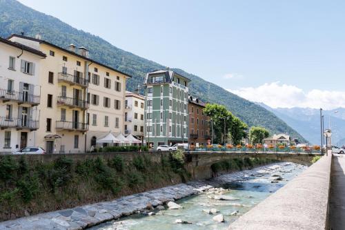 a bridge over a river in a city with buildings at Hotel Stelvio Tirano in Tirano
