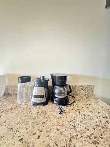 a kitchen counter with two appliances on a counter top at Spacious 3 Bed Home, Pool & Gym Access in Steer Town