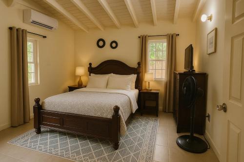a bedroom with a bed and a television in it at Spacious 3 Bed Home, Pool & Gym Access in Steer Town