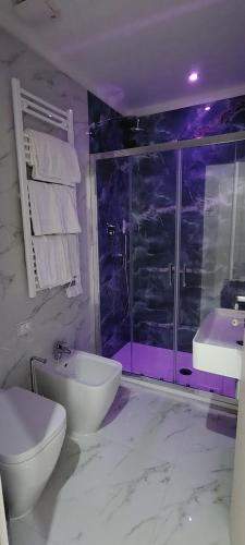 a bathroom with a toilet and a sink and a shower at Hotel Margot in Milan