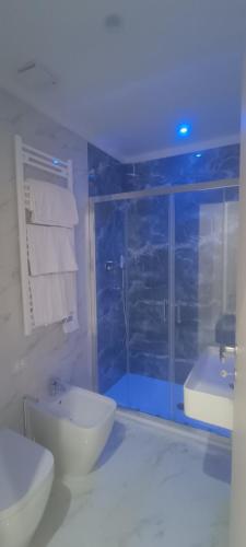 a bathroom with a shower and a toilet and a sink at Hotel Margot in Milan