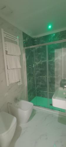 a white bathroom with a toilet and a sink at Hotel Margot in Milan