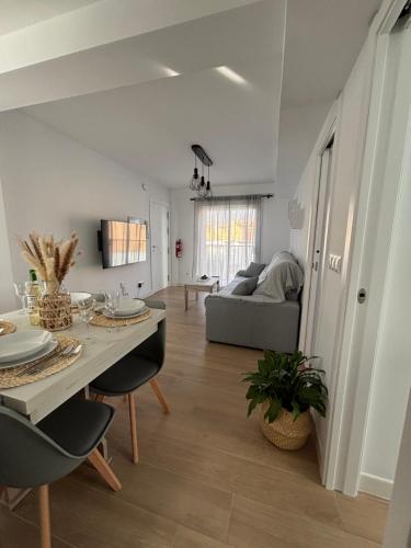 a living room with a table and a couch at Apartamento García in Nerja