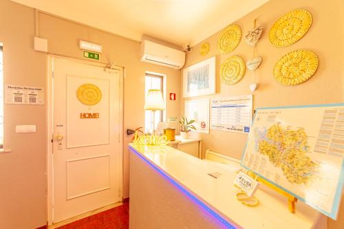 a classroom with a white counter and a white door at 4Ever Palace Design&Nature in Alcácer do Sal