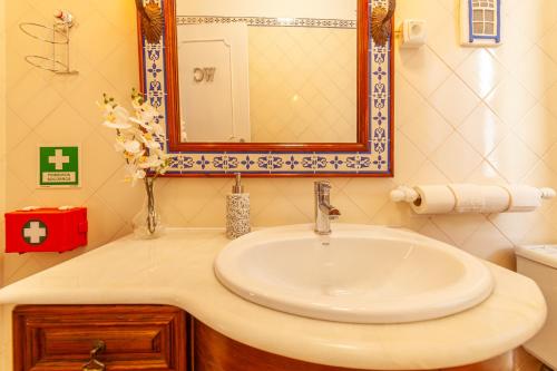 a bathroom with a sink and a mirror at 4Ever Palace Design&Nature in Alcácer do Sal
