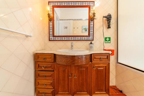 a bathroom with a sink and a mirror at 4Ever Palace Design&Nature in Alcácer do Sal