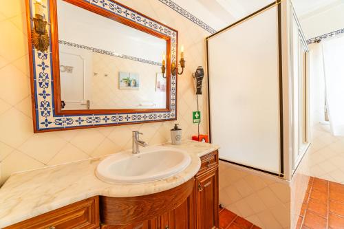 a bathroom with a sink and a mirror at 4Ever Palace Design&Nature in Alcácer do Sal