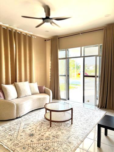 a living room with a couch and a table at House at Pantai Sepat 2BR Netflix Coway in Kuantan