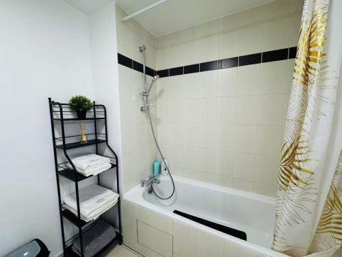 a bathroom with a shower and a white bath tub at Proche Disney Paris Appartement cosy et familial pour 4 Pers-Wifi-Parking Privé in Bussy-Saint-Georges