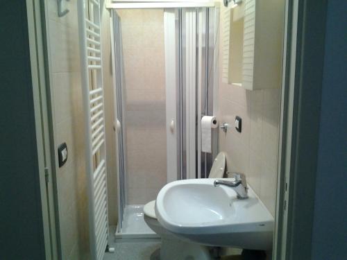 a bathroom with a sink and a toilet and a shower at Dimora Marcelo in Parabita