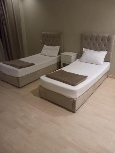 two beds sitting next to each other in a room at لؤلؤة الرياض in Riyadh