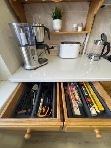 a kitchen drawer filled with lots of cooking utensils at Dani apartment in Panevėžys