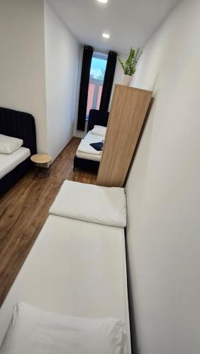 a small room with a bed and a table at Apartment Lovro in Ivanec