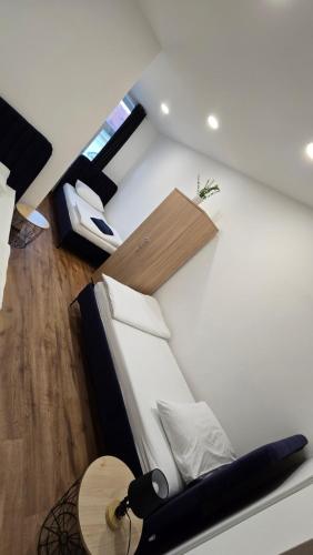 a living room with a bed and a table at Apartment Lovro in Ivanec