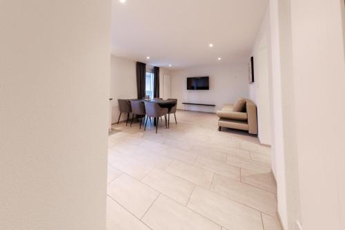 a living room with a table and chairs at Einladende Wohnung in der Stadt! in Winterthur