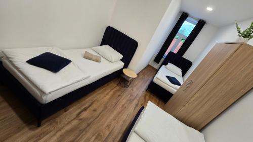 a small bedroom with a bed and a chair at Apartment Lovro in Ivanec