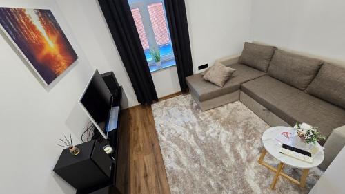 a small living room with a couch and a table at Apartment Lovro in Ivanec