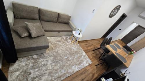 a living room with a couch and a table at Apartment Lovro in Ivanec