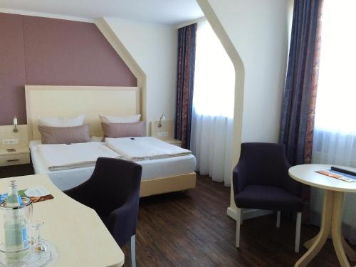 Кровать или кровати в номере Landhotel Alte Schule - Hotel Garni