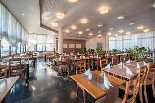a dining room with wooden tables and chairs at Belvedere Resort Hotels in Izola