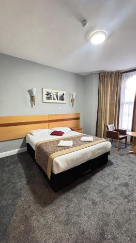 a bedroom with a large bed in a room at Newham Hotel in London