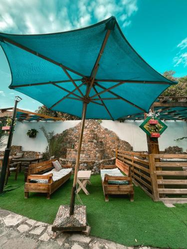 a large blue umbrella sitting on the grass at Tarakhan Hotel in Dahab