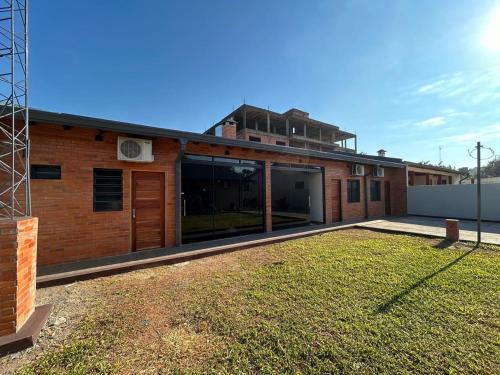 a house with a large yard in front of it at MH Hostel in Encarnación