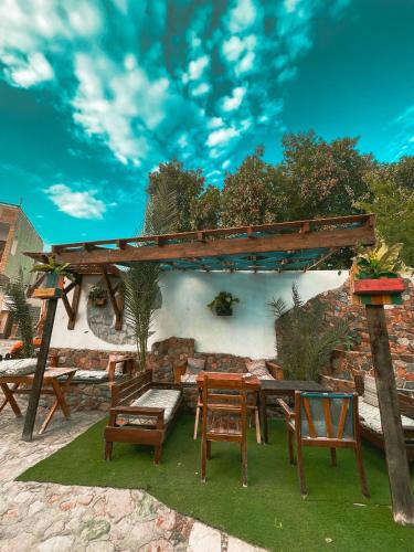 a picnic table and chairs under a wooden pergola at Tarakhan Hotel in Dahab