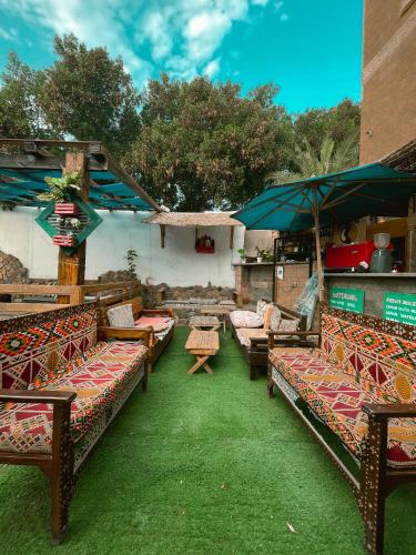 a group of benches with tables and umbrellas at Tarakhan Hotel in Dahab