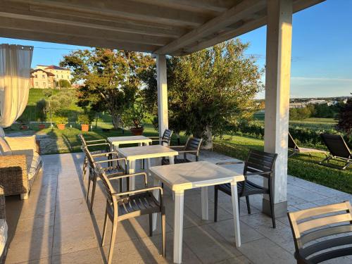 a patio with tables and chairs on a patio at Agriturismo Vecio Portico in Marostica