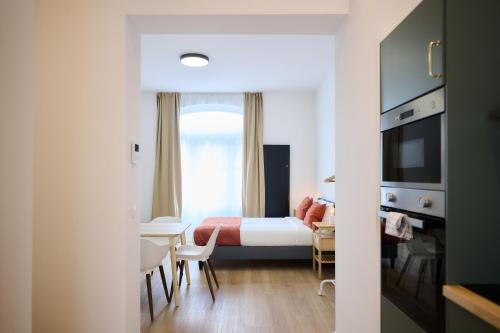 a hotel room with a bed and a table and chairs at Apartment Berthelot 5 in Brussels