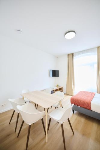 a bedroom with a table and chairs and a bed at Apartment Berthelot 5 in Brussels