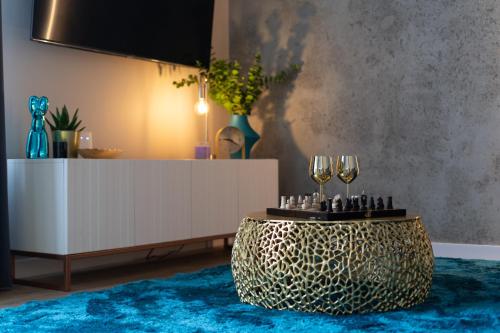 a living room with a table with wine glasses on it at LIFESTYLE Apartments in Bochnia