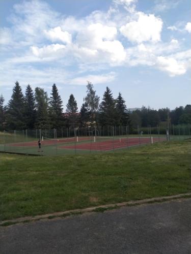 a tennis court in a park with trees at Studio in Les Rousses