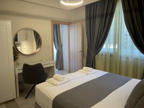 a bedroom with a bed and a desk and a mirror at La casa de verano in Skala Sotiros