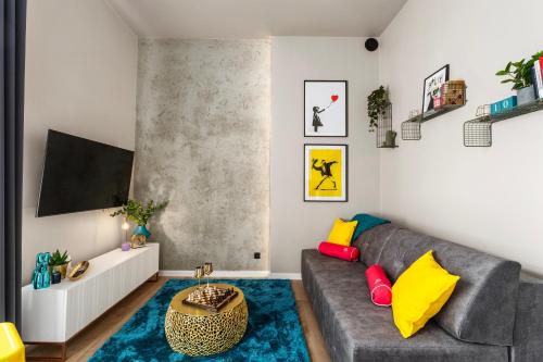a living room with a gray couch and a blue rug at LIFESTYLE Apartments in Bochnia