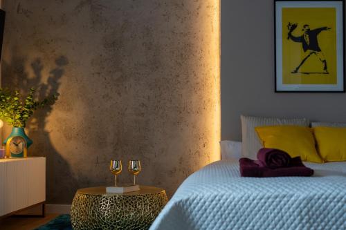 a bedroom with a bed and a table with wine glasses at LIFESTYLE Apartments in Bochnia