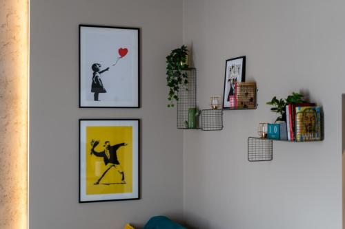 a wall with four pictures of a woman holding a balloon at LIFESTYLE Apartments in Bochnia
