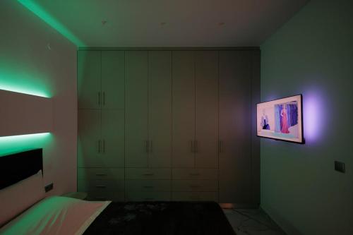 a bedroom with a bed and a painting on the wall at Urban Energy Suites in Heraklion