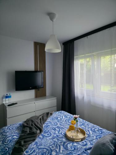 a bedroom with a bed with a tray with two oranges on it at Apartament Anny in Grodzisk Mazowiecki