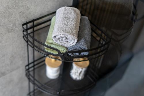 a towel rack with two towels and a pair of socks at LIFESTYLE Apartments in Bochnia