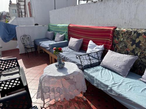 a couch sitting on a patio with a table at The Medina Riad in Tangier