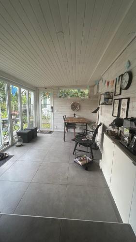 a room with a table and chairs in a house at Strandstugan in Halmstad